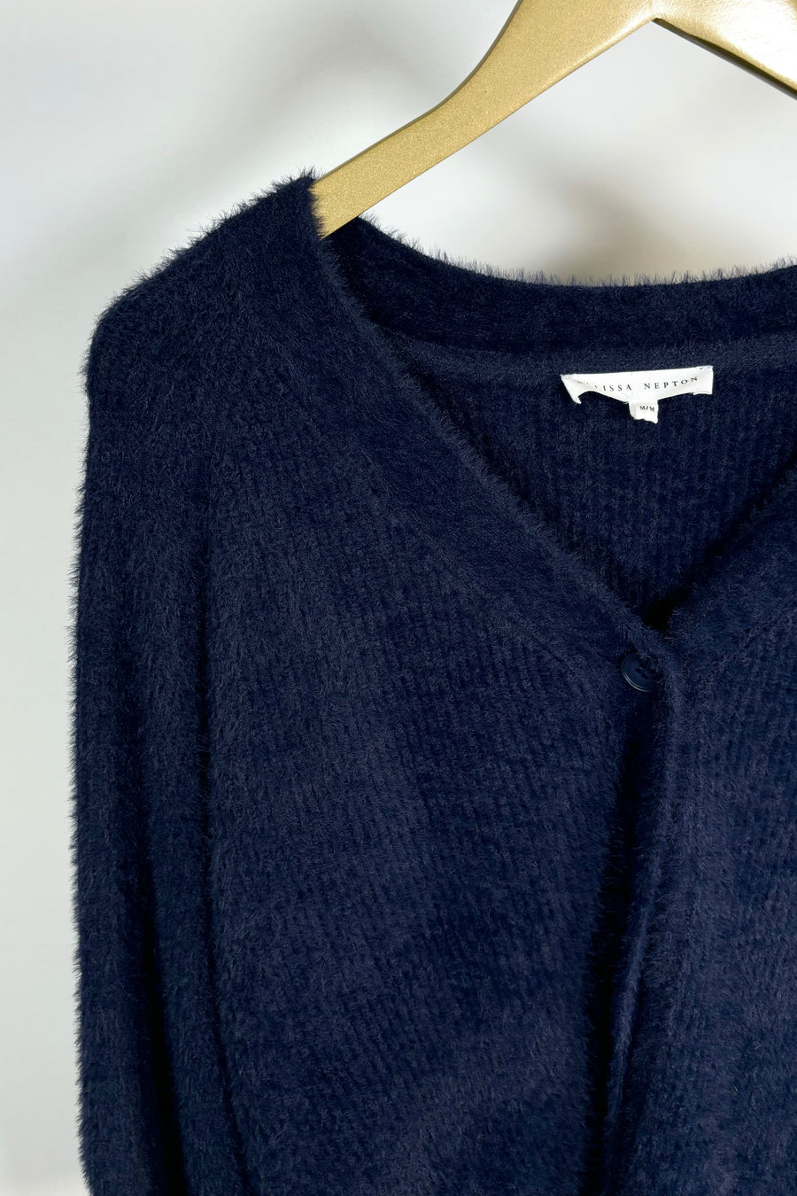 Close-up view of navy blue knit cardigan