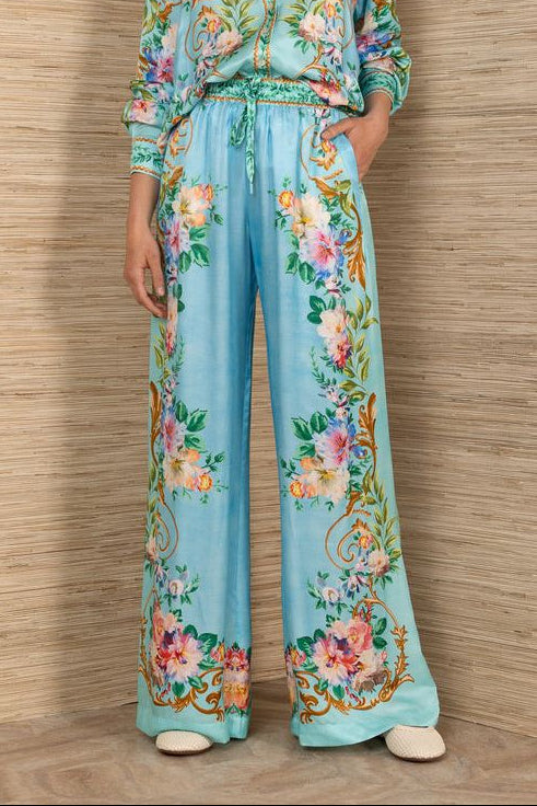 woman wearing a turquoise floral patterned drawstring pants
