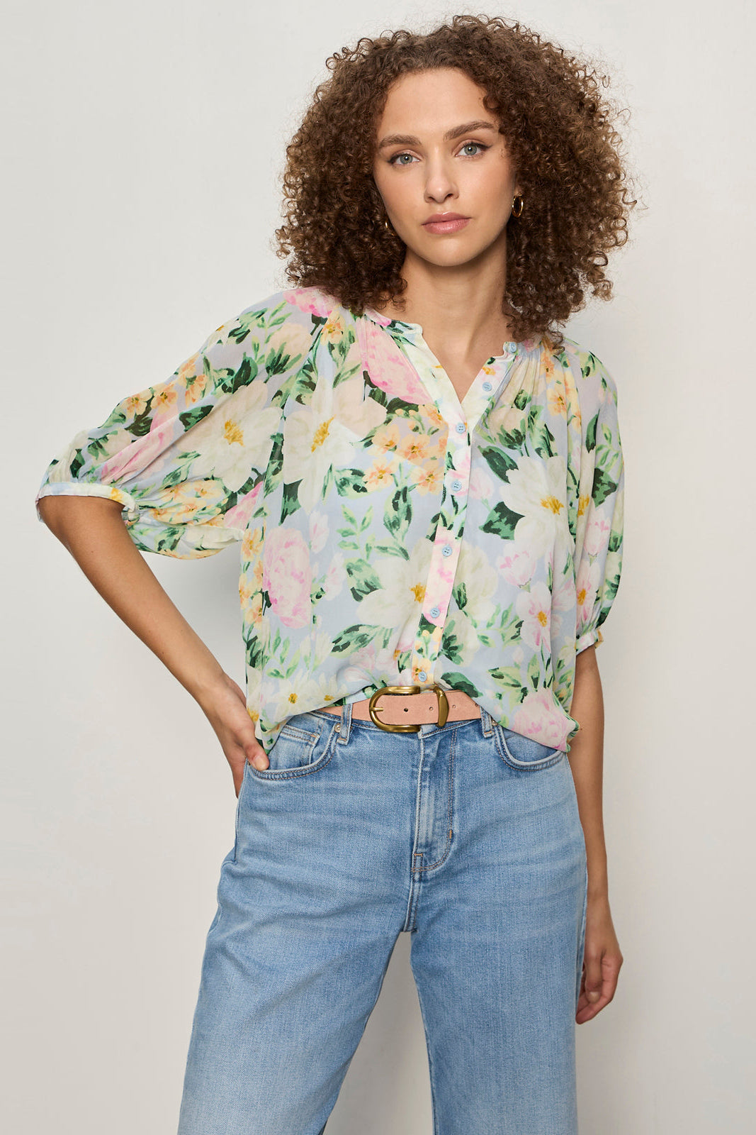 front view of half sleeve floral print sheer button down blouse