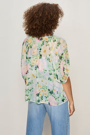 back view of half sleeve floral print sheer button down blouse