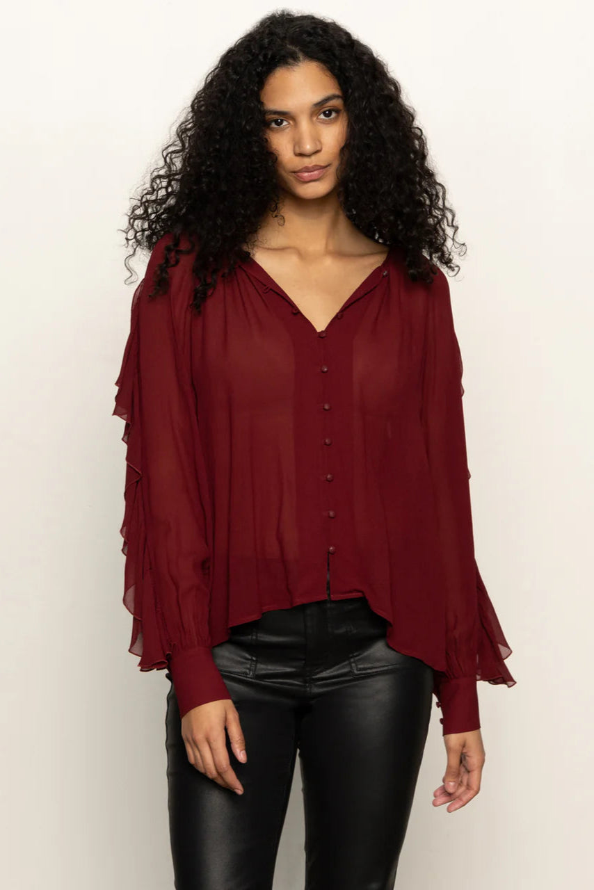 woman wearing a red button front ruffly blouse