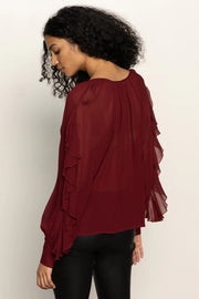 woman wearing a red button front ruffly blouse