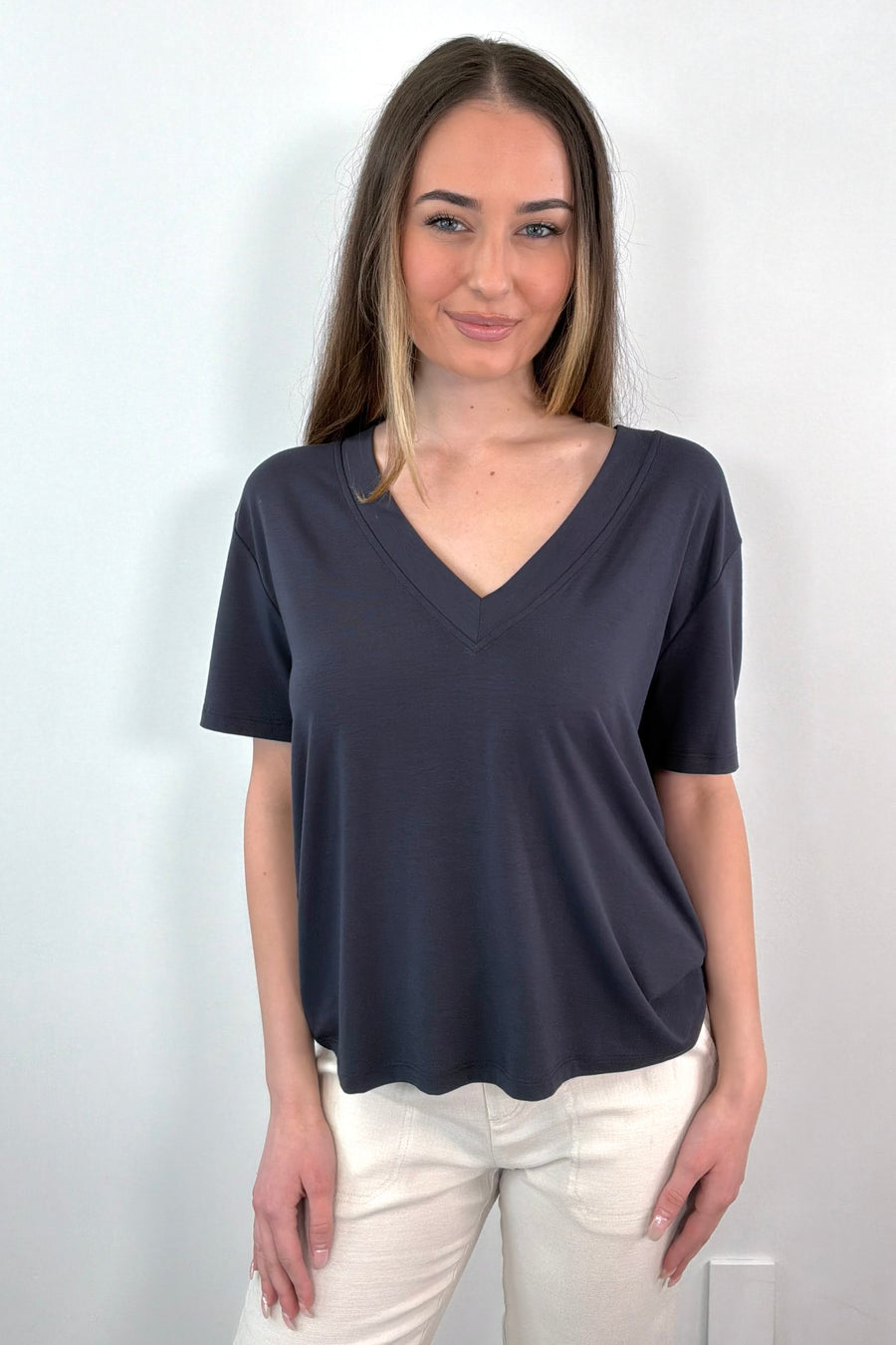 Woman wearing a navy V-neck t-shirt 