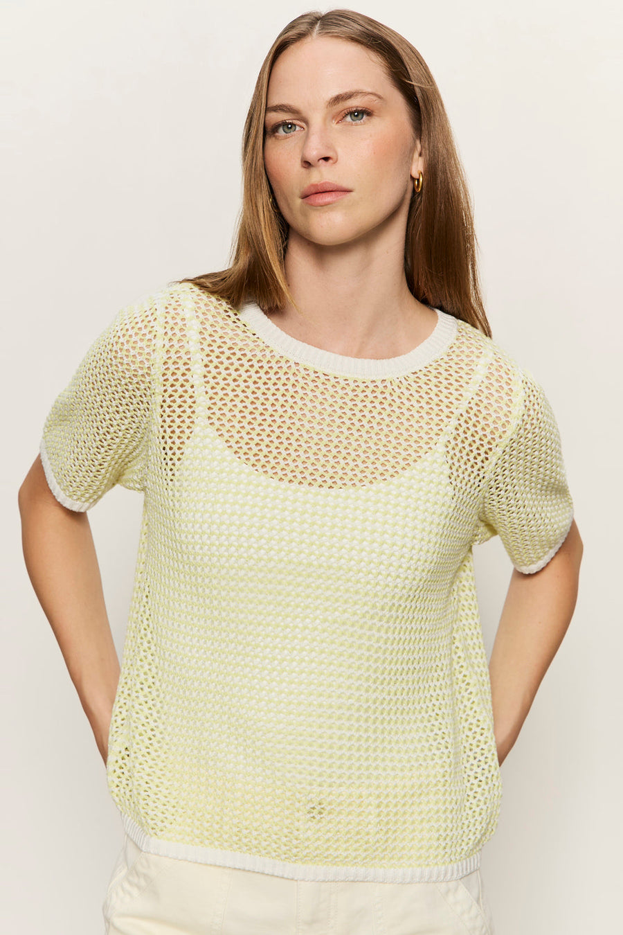 front view of light yellow open knit sweater