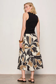 Woman wearing a black midi dress with lotus pattern detail 