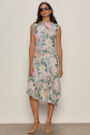 a woman wearing a floral print sleeveless midi asymmetrical dress 