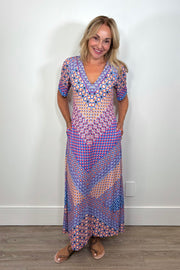 Front view of woman wearing a patterned jersey midi dress