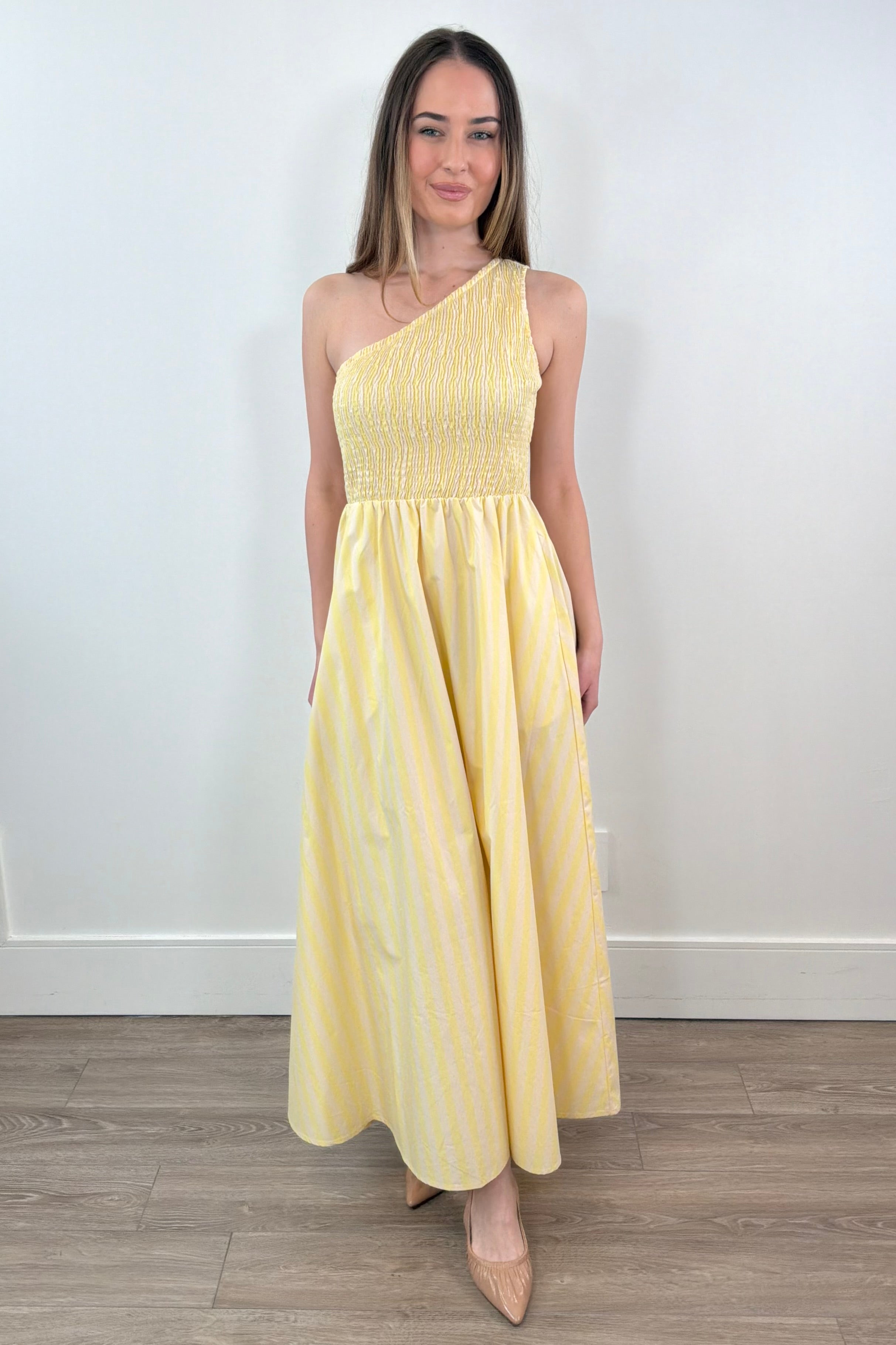 woman wearing a one-shoulder elastic torso yellow and white stripped dress