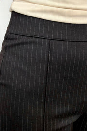 Person wearing black pinstripe pants
