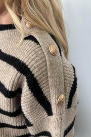 Close-up of the shoulder of a sweater with button embellishments 