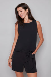 woman wearing sleeveless vegan silk black top
