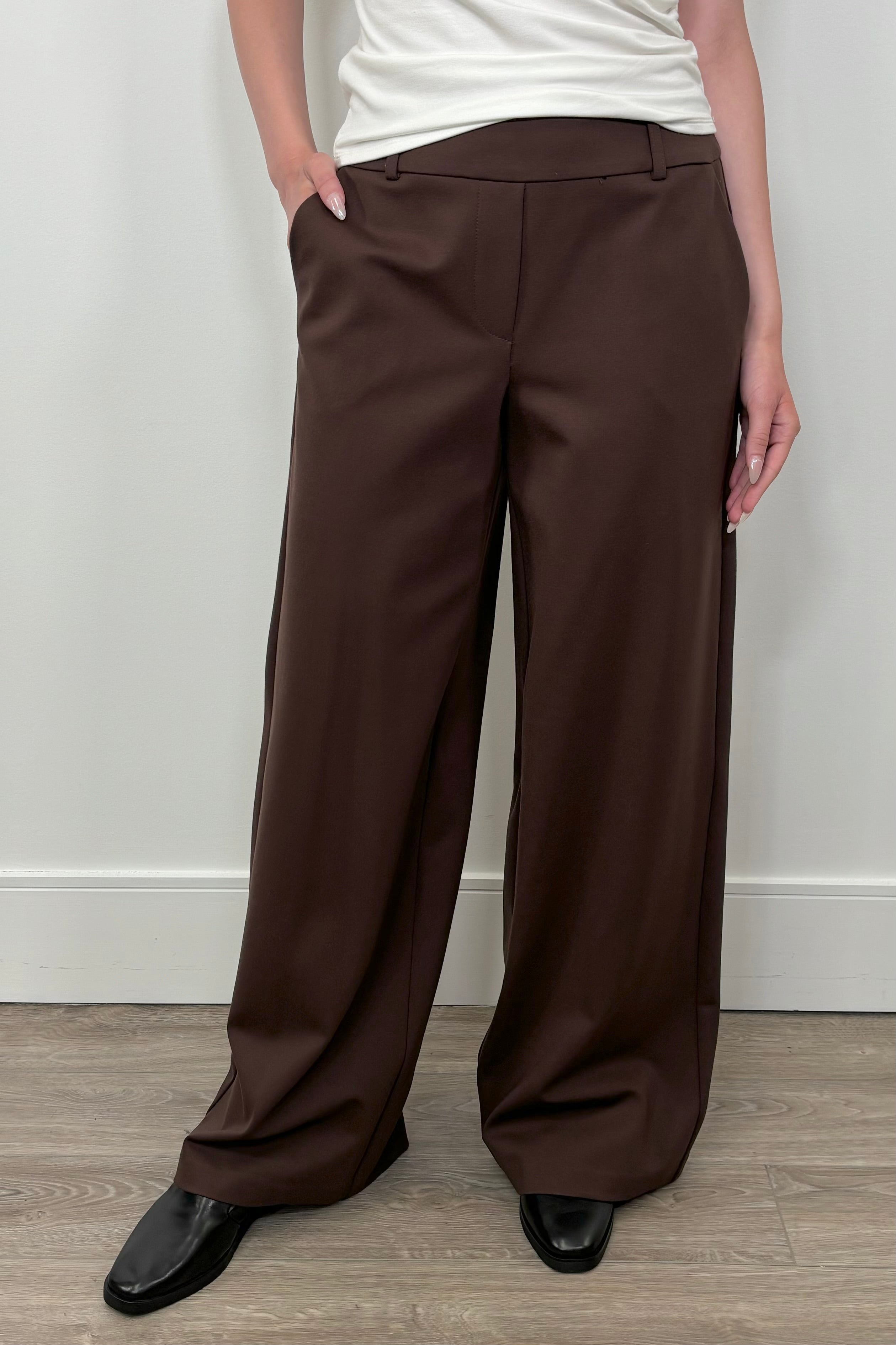 Front view of woman wearing a brown wide leg ponte pant