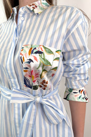 close- up of a white and blue striped dress with a silk floral patterns
