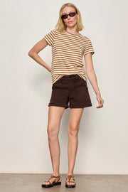 Woman wearing brown shorts with a relaxed fit