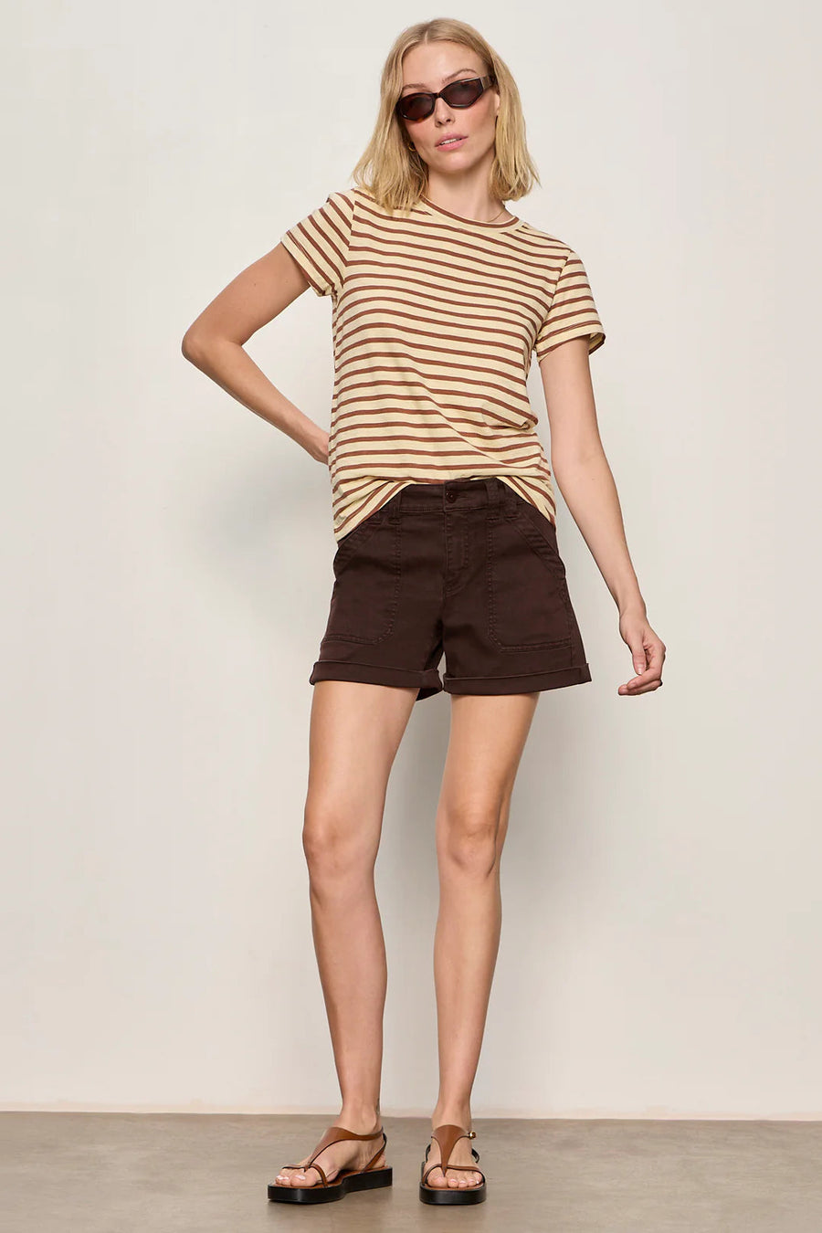 Woman wearing brown shorts with a relaxed fit