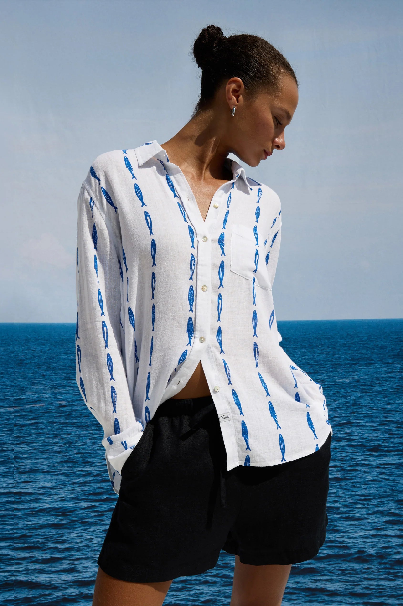 White button up blouse with a blue sardine pattern