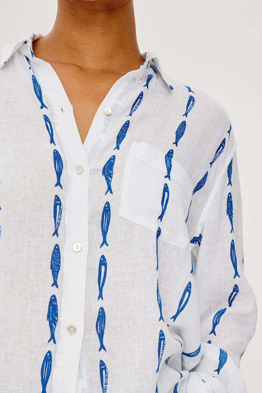 White button up blouse with a blue sardine pattern