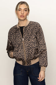 Front view of woman wearing a zipped up leopard print bomber jacket