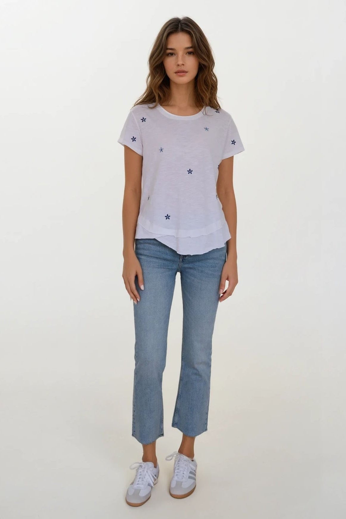 woman wearing white mock layer t shirt with start details 