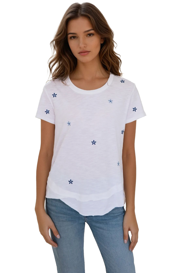 close up of woman wearing white mock layer t shirt with start details 