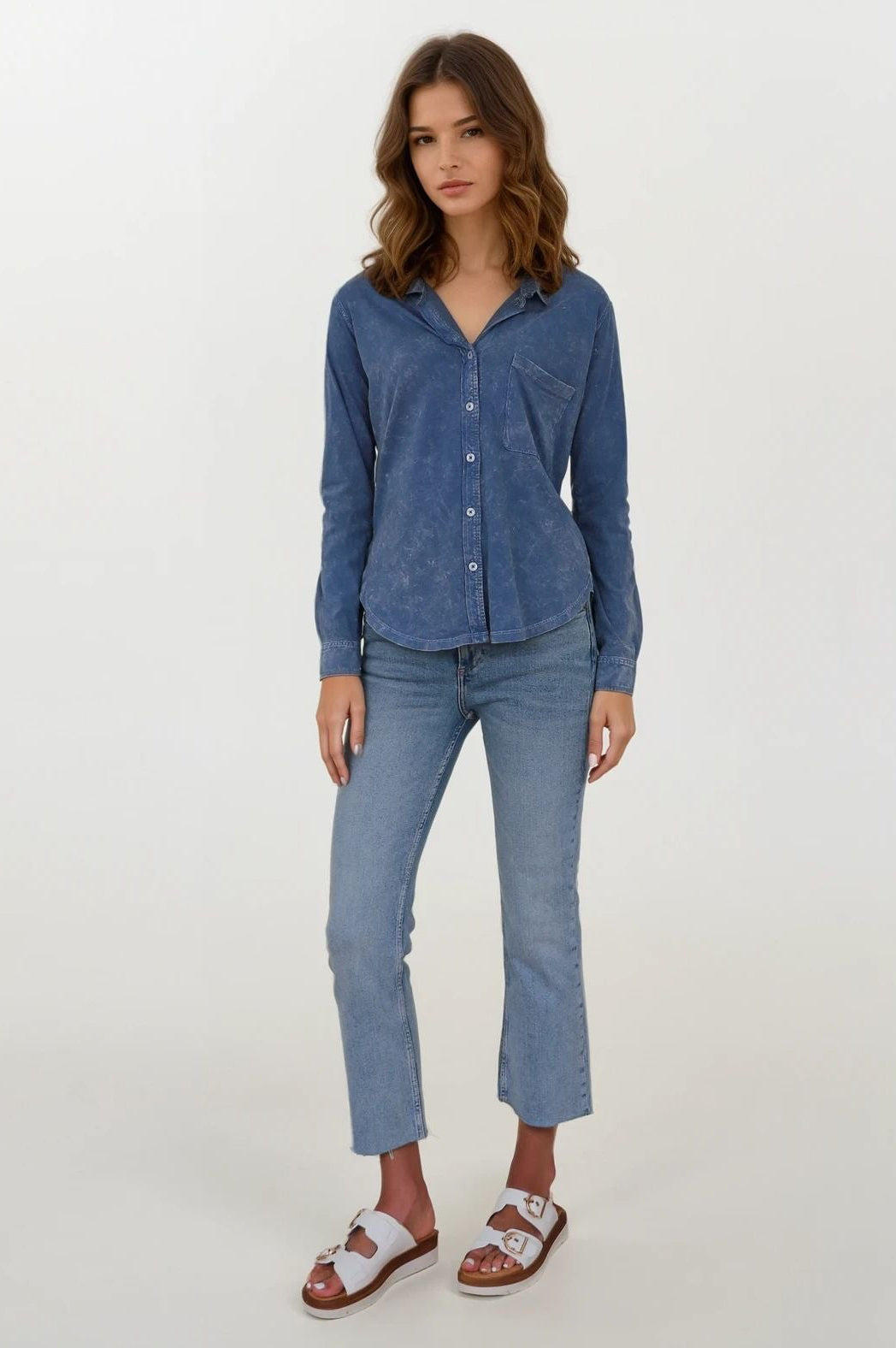 woman wearing a washed blue button up blouse