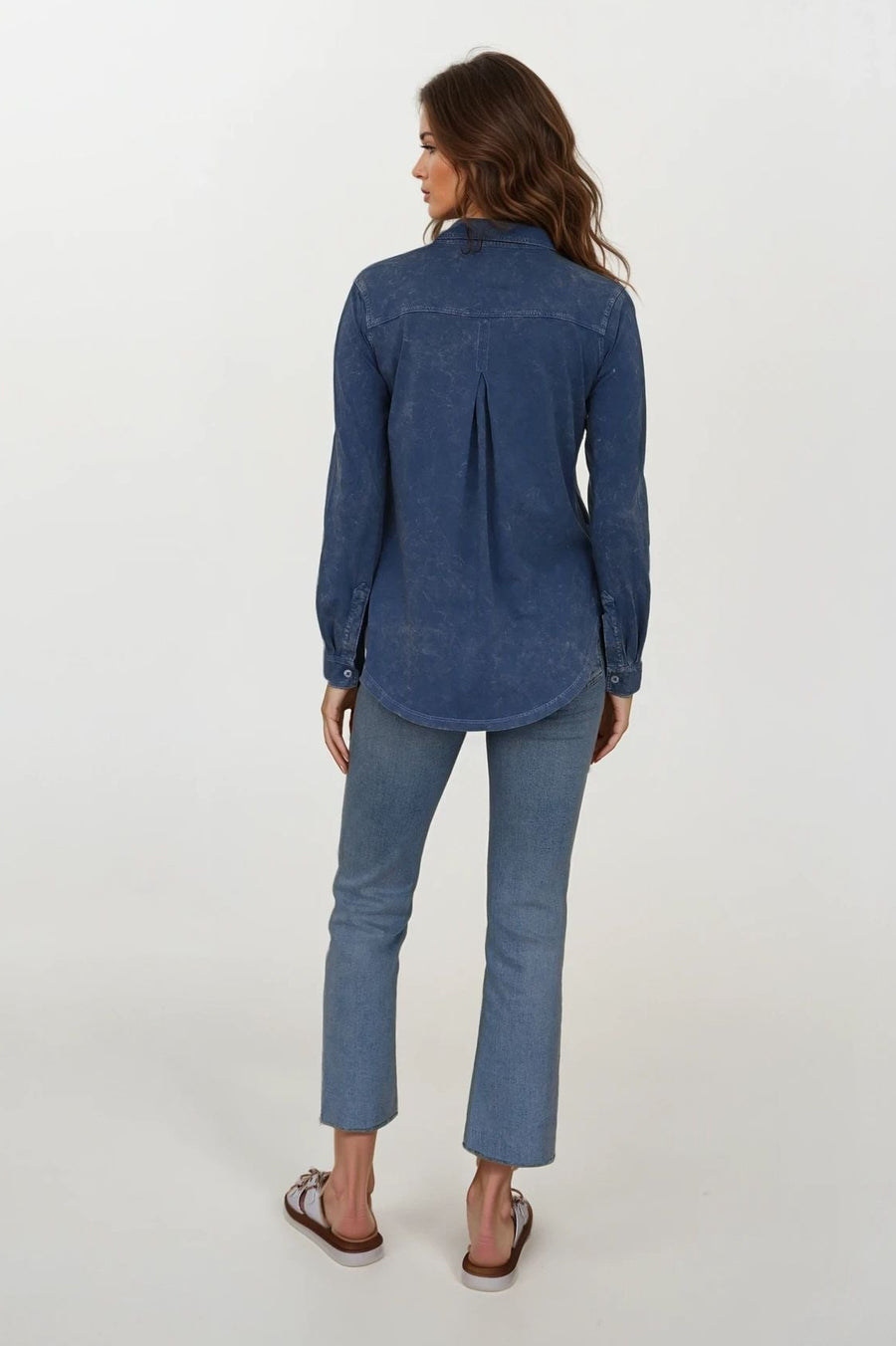 back view of woman wearing washed blue button up blouse