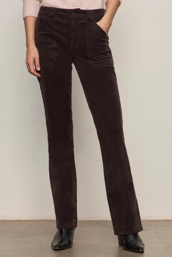 Person wearing brown corduroy pants against a plain background