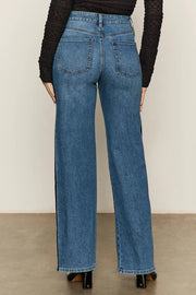 woman wearing a relaxed straight leg jeans with a stripe on the sides