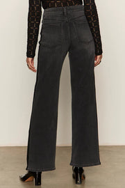 woman wearing washed black relaxed straight jean with lines on the sides