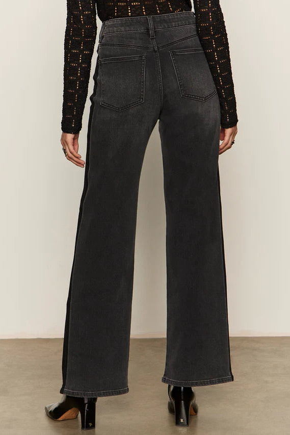 woman wearing washed black relaxed straight jean with lines on the sides