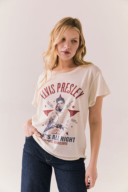 Woman wearing a t-shirt with Elvis Presley graphic design on a plain background