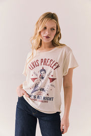 Woman wearing a t-shirt with Elvis Presley graphic design on a plain background