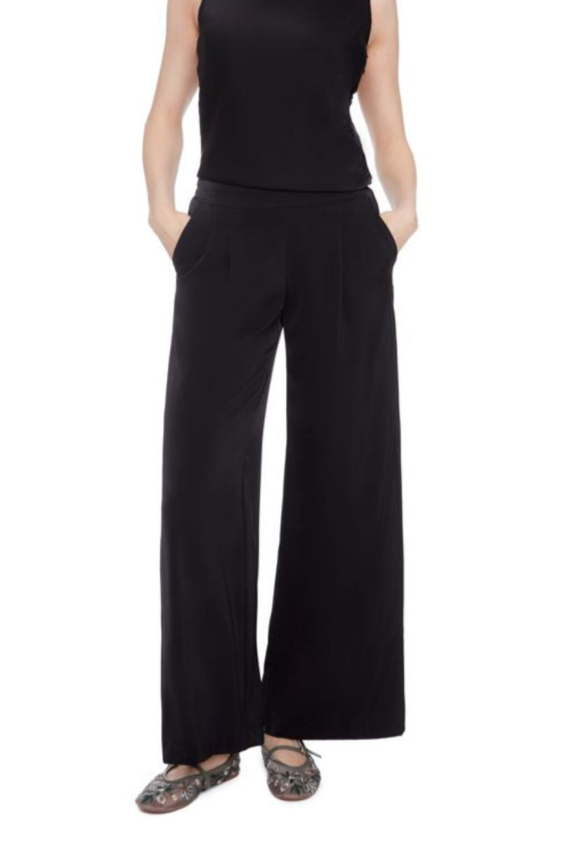 Front view of a woman wearing matching black satin sleeveless top and wide-leg pants on a white background