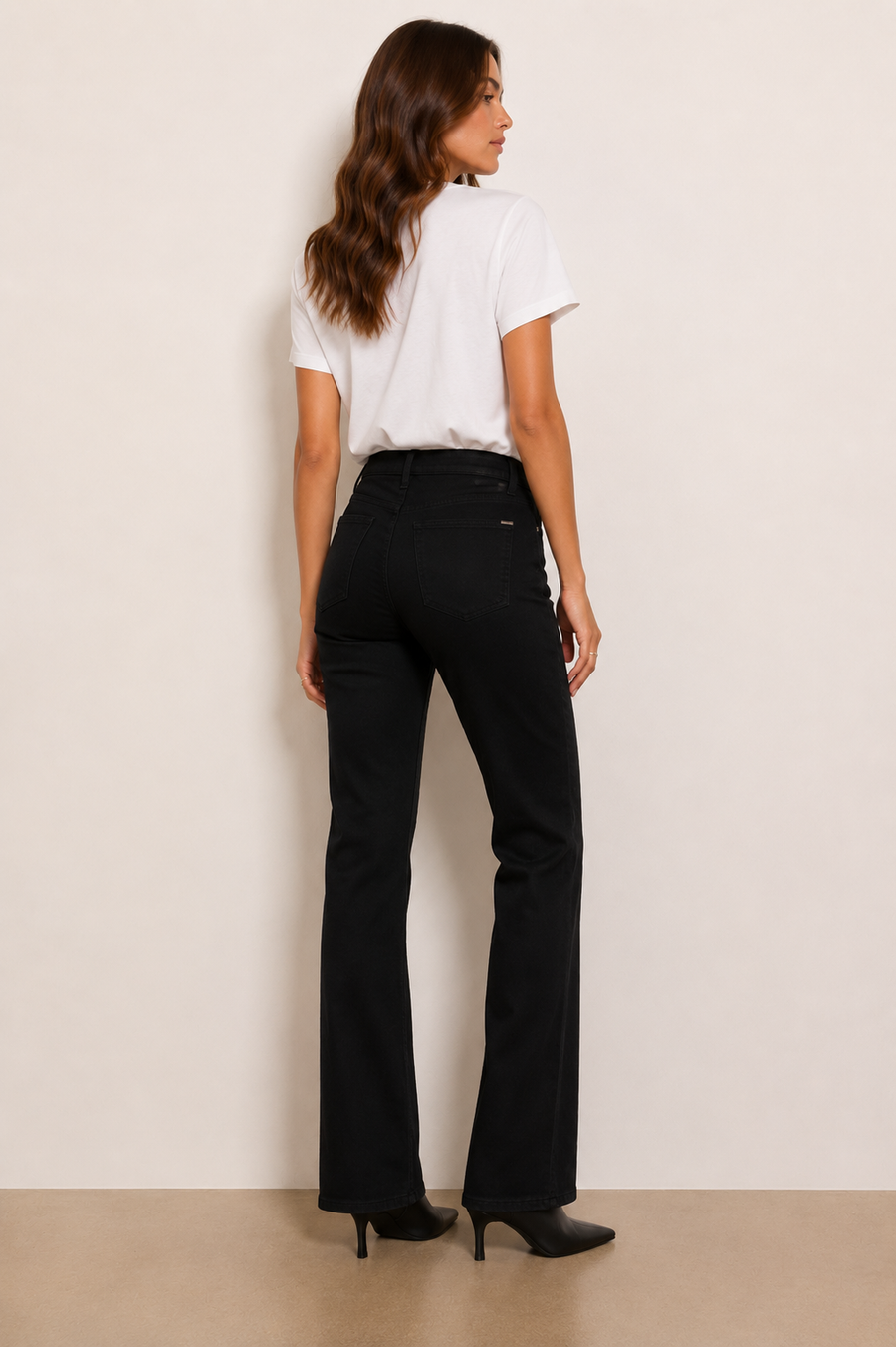 Woman wearing black boot cut pants. 