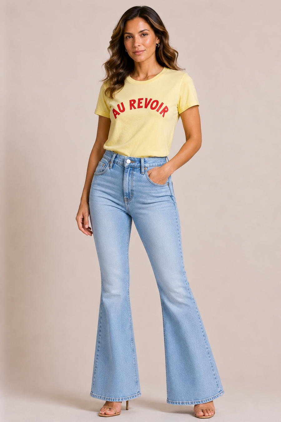 Woman wearing a butter yellow t-shirt with 'AU REVOIR' in pink text