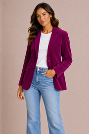 Woman wearing a pink berry velvet blazer