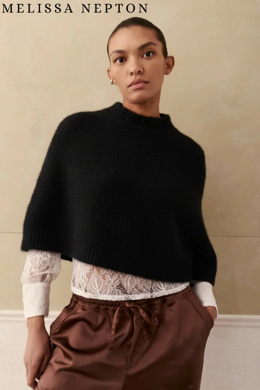 woman wearing black cape sweater 