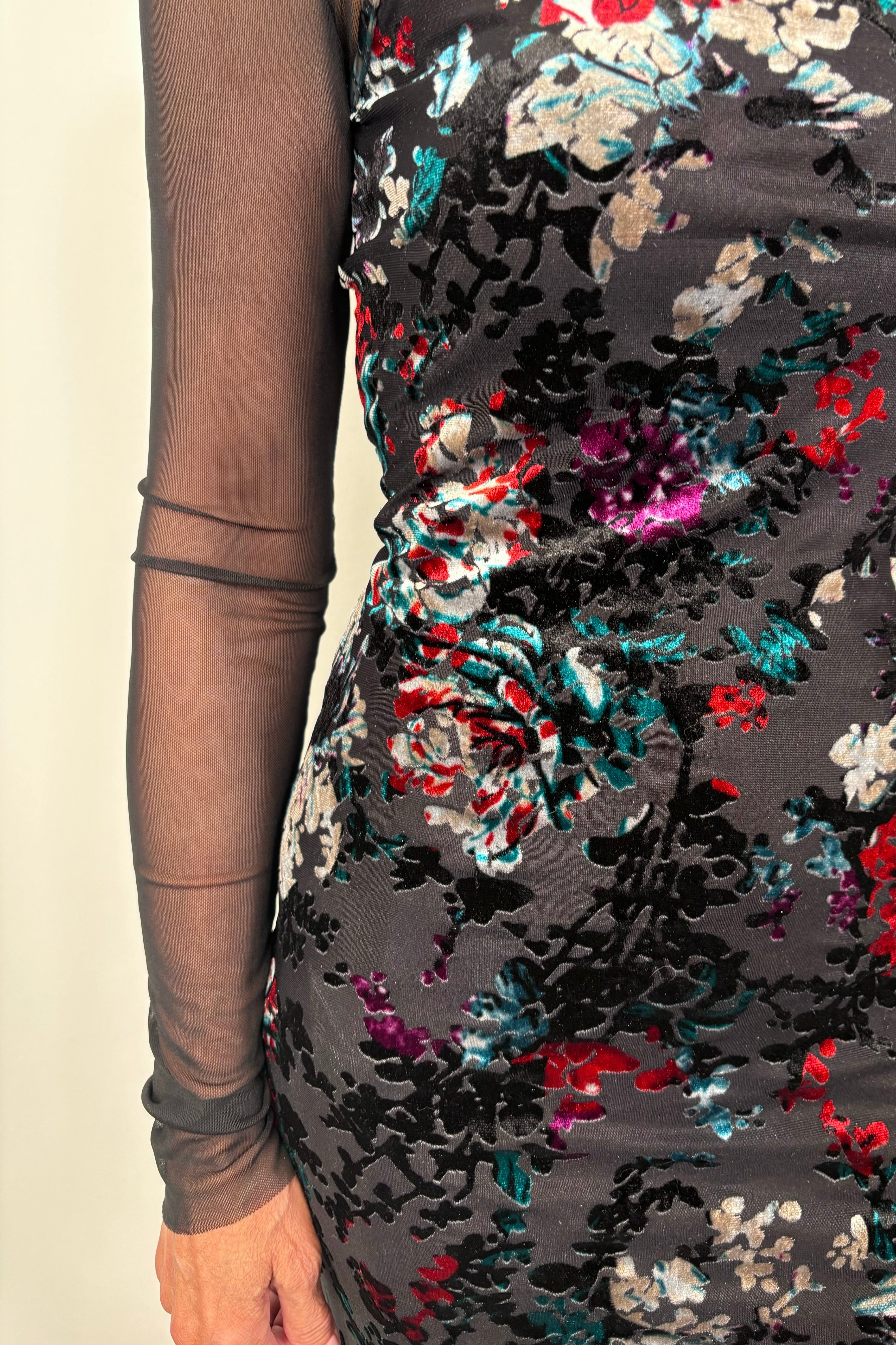 Close-up of a floral maxi fitted dress with velvet detailing and a long sleeve mesh under tee