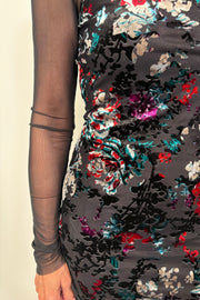 Close-up of a floral maxi fitted dress with velvet detailing and a long sleeve mesh under tee