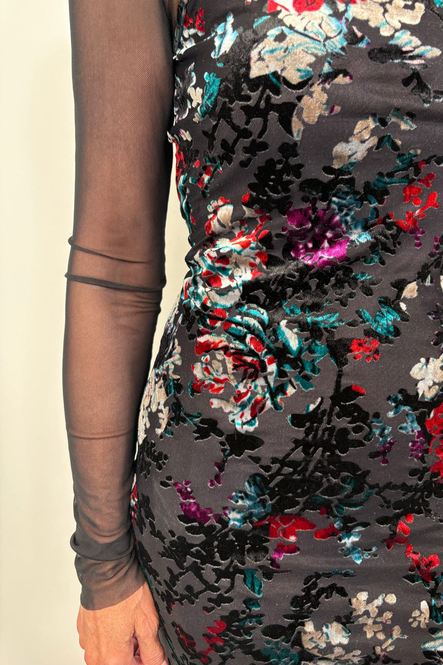 Close-up of a floral maxi fitted dress with velvet detailing and a long sleeve mesh under tee