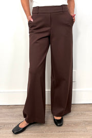 Brown wide-leg pants worn by a person on a plain background