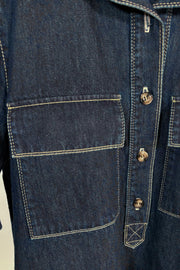 Close-up of the pocket of a dark blue denim dress 