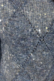Close-up of a textured gray fabric surface with small holes and imperfections.