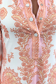 Women wearing v-neck dress with pink and orange patterns 