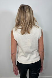 Back view of a woman wearing a sleeveless mix media tank top