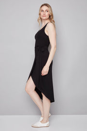 woman wearing a black midi dress with bow detailing n the side