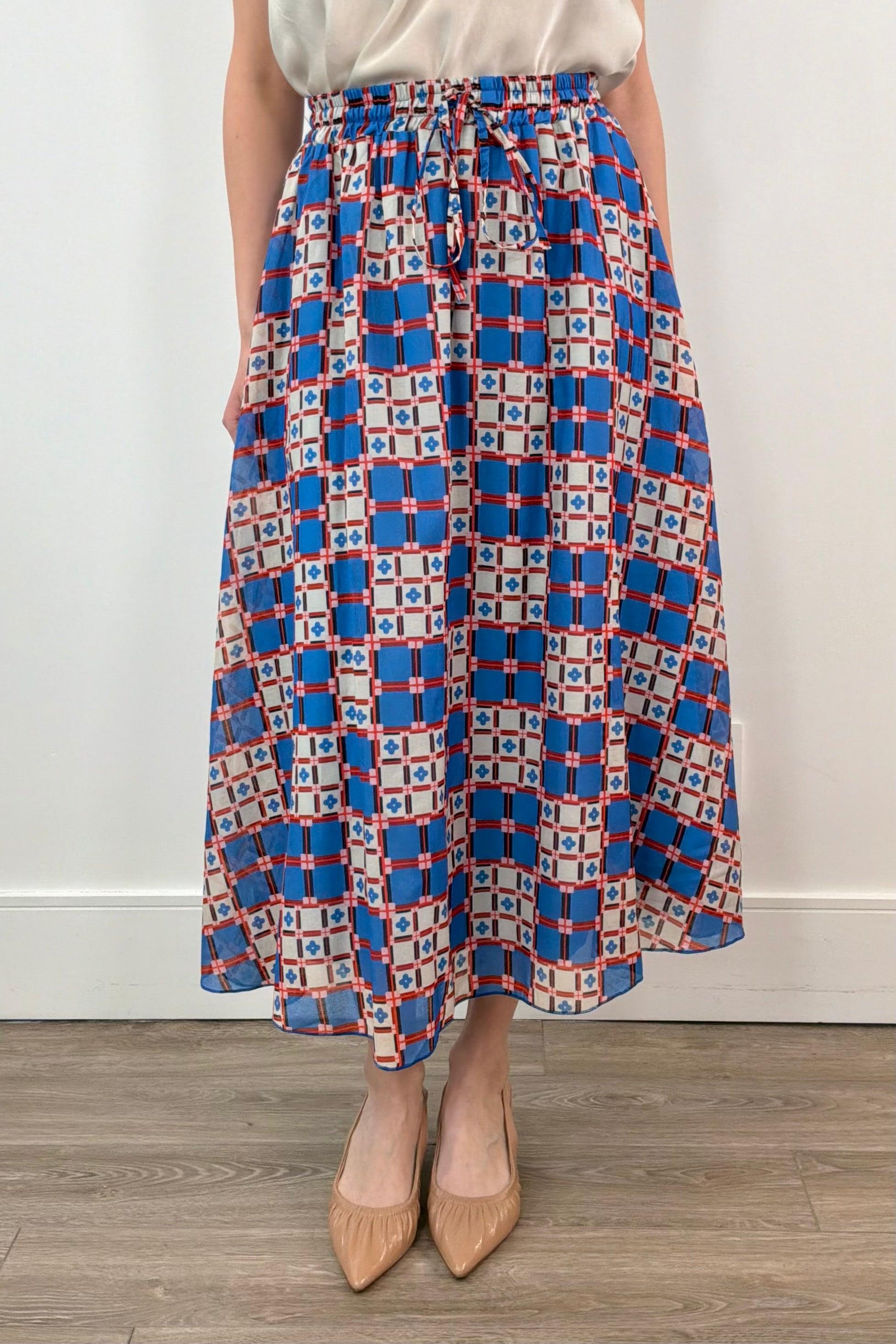 woman wearing an azulejos patterned midi skirt 