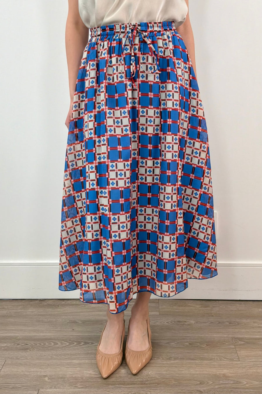 woman wearing an azulejos patterned midi skirt 