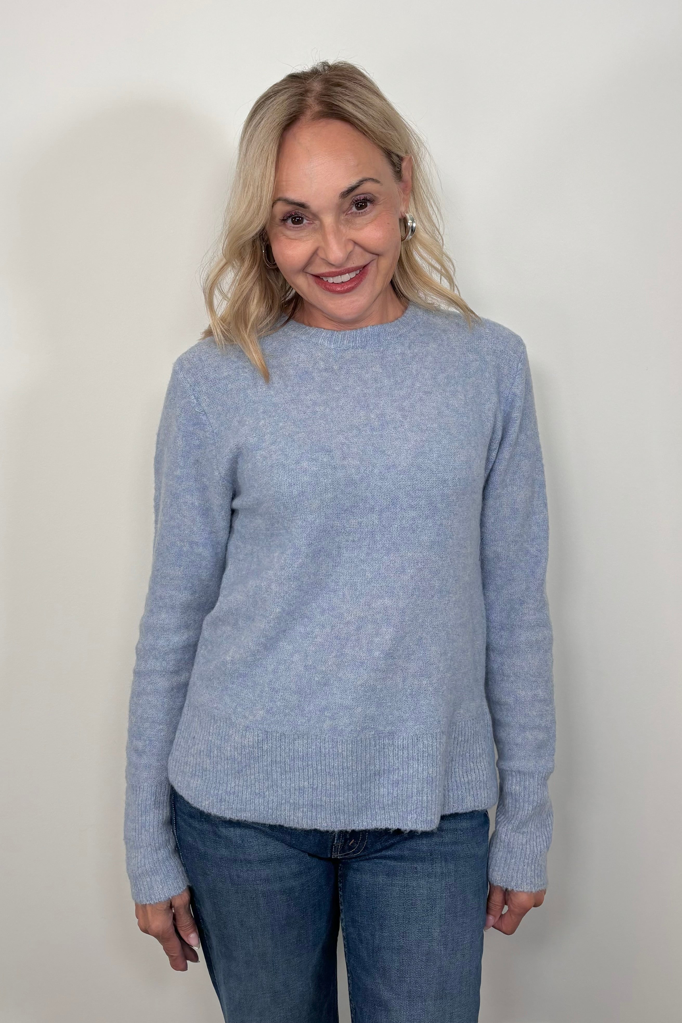 Front view of woman wearing a light blue sweater 