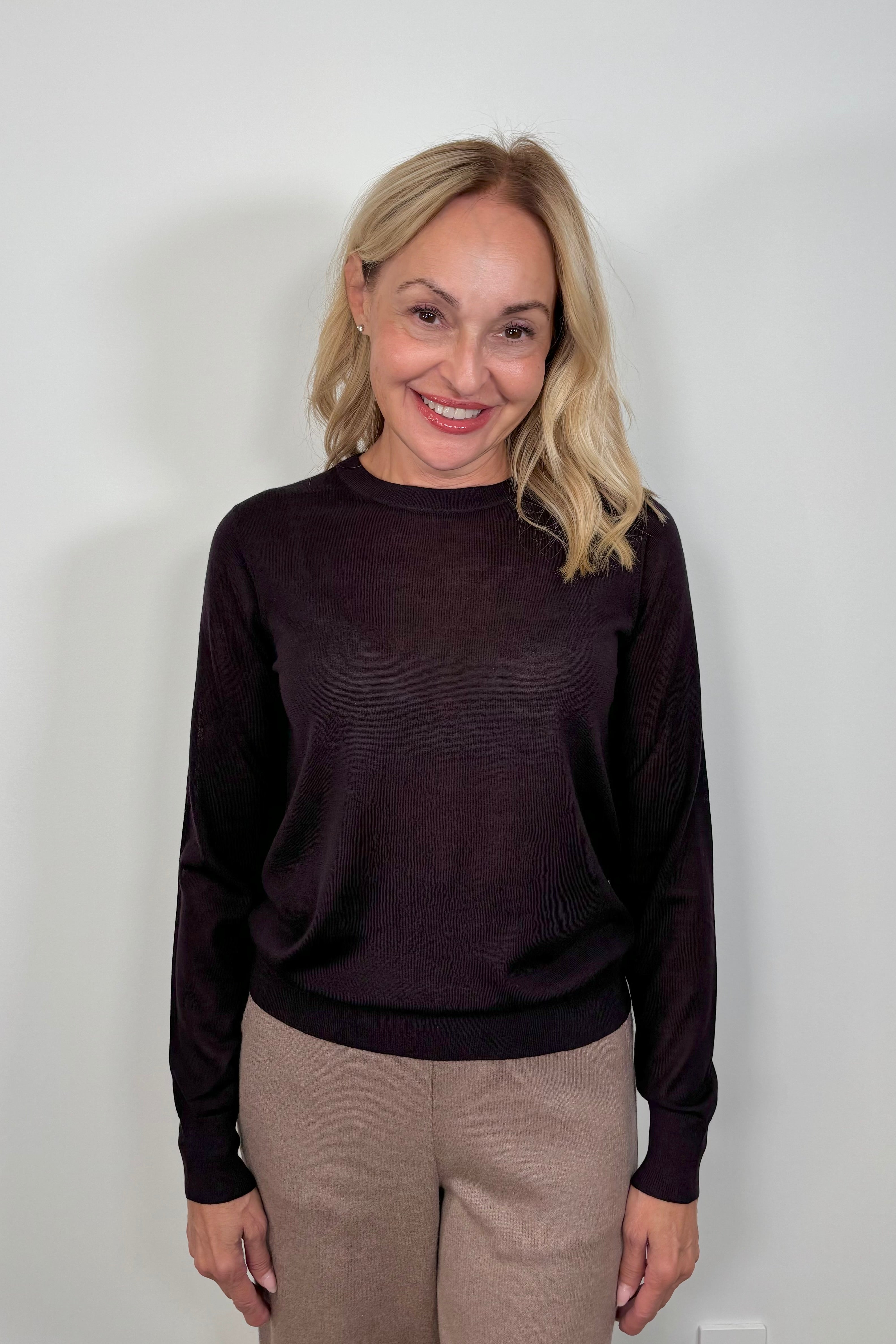 woman wearing a fine purple merino crew neck 